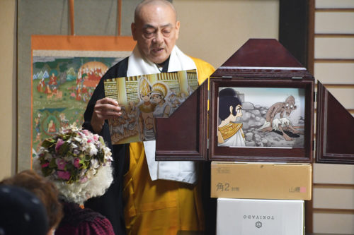 （画像1：法話に代えて釈尊の紙芝居を演じる今井住職）